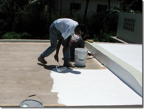 Roofer applying roof coating in Chillum, MD